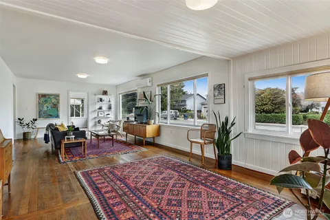 a living room with furniture rug and a table