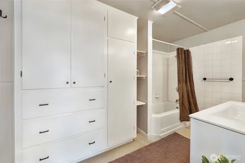 a bathroom with a shower and closet