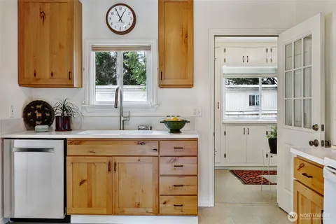 a bathroom with a sink a mirror and a window