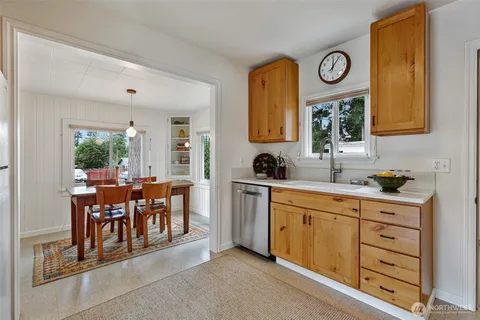 a very nice looking dining room with cabinets