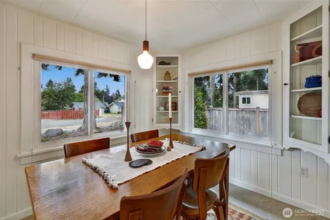 a view of a dining room with furniture large windows and wooden floor