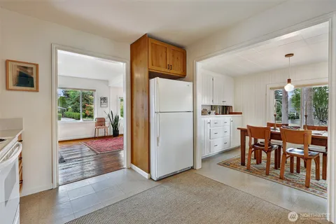 a view of kitchen with furniture and refrigerator