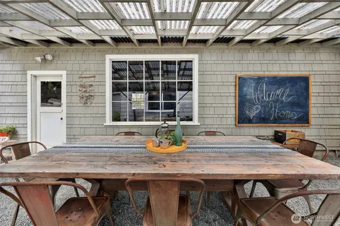 a wooden table and chairs in front of door