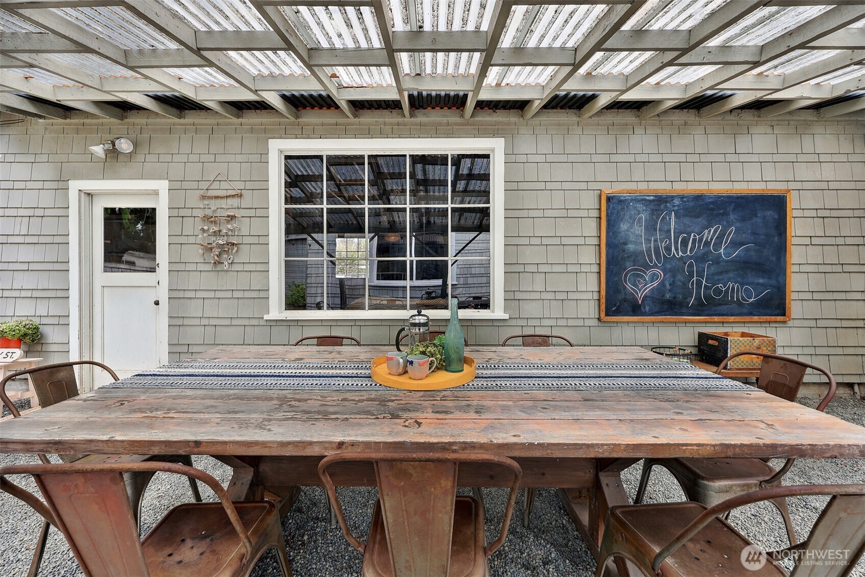 16003 15th Avenue Southwest Burien, WA 98166 - Photo 32 of 36 a wooden table and chairs in front of door