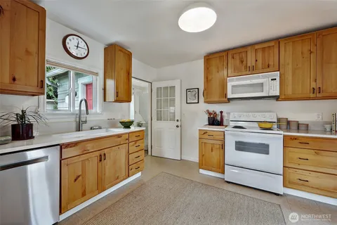 a kitchen with stainless steel appliances granite countertop a stove and a sink