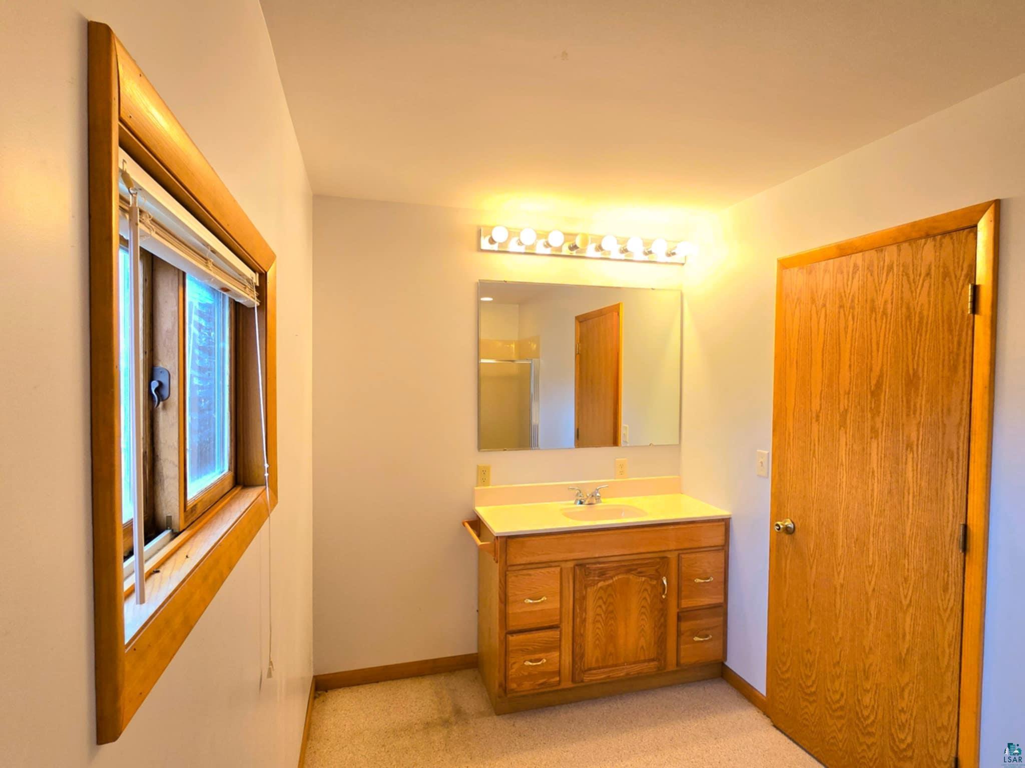 66282 County Rd C Marengo, WI 54855 - Photo 15 of 31 Bathroom with vanity and a shower with door