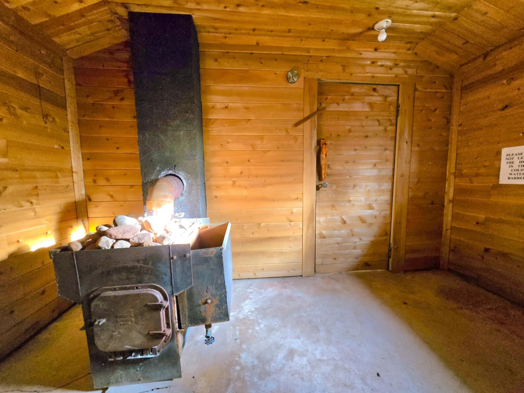 66282 County Rd C Marengo, WI 54855 - Photo 25 of 31 Interior space with a wood stove, wood walls, and wood ceiling