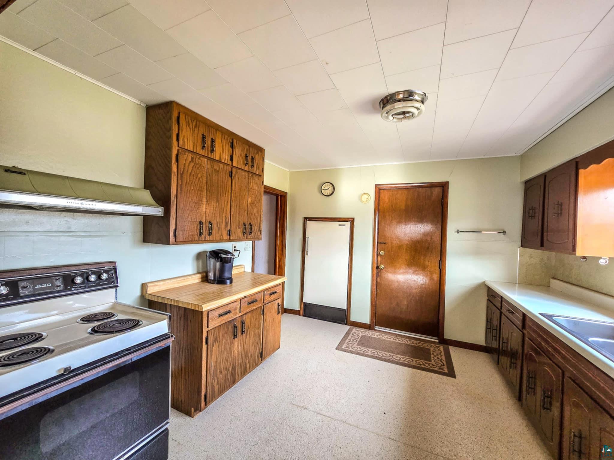 66282 County Rd C Marengo, WI 54855 - Photo 5 of 31 Kitchen featuring wooden counters, white electric stove, and sink