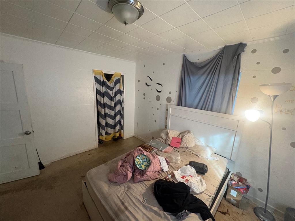 2330 Azalea Court Lakeland, FL 33815 - Photo 20 of 37 a bedroom with a bed and a wooden floor