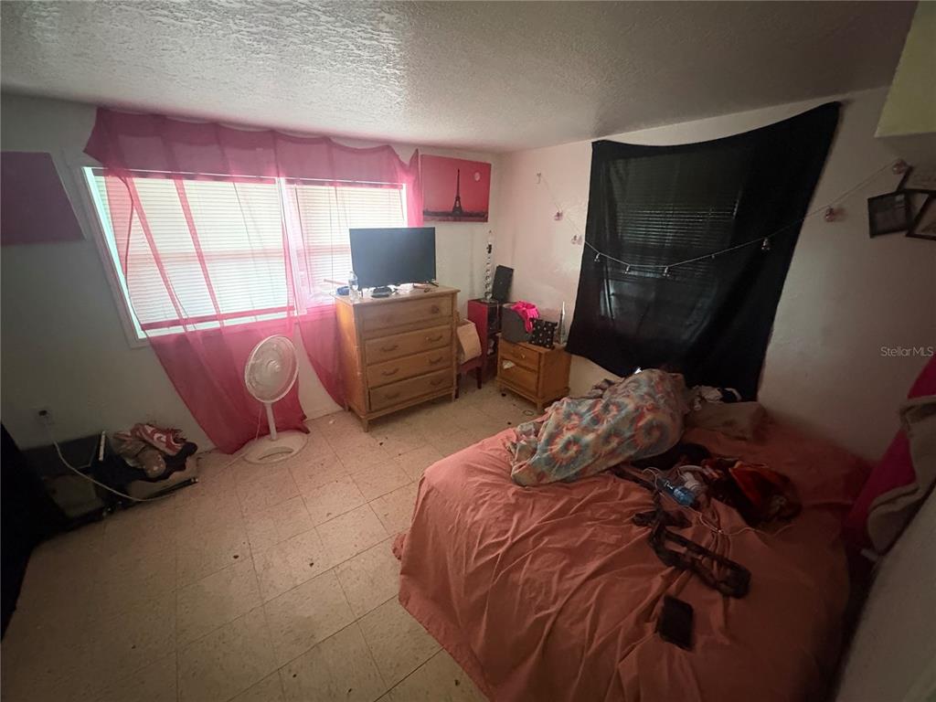 2330 Azalea Court Lakeland, FL 33815 - Photo 4 of 37 a bed sitting in a bedroom next to a window