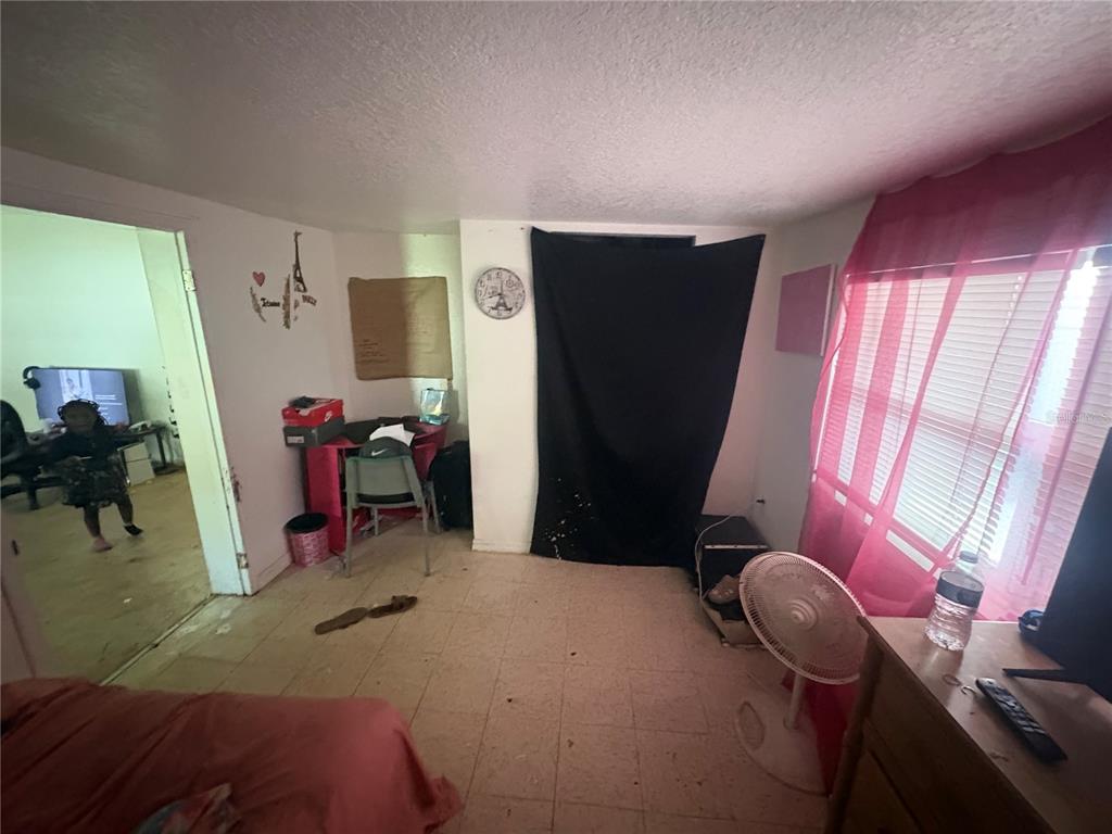 2330 Azalea Court Lakeland, FL 33815 - Photo 5 of 37 a bedroom with furniture and a window