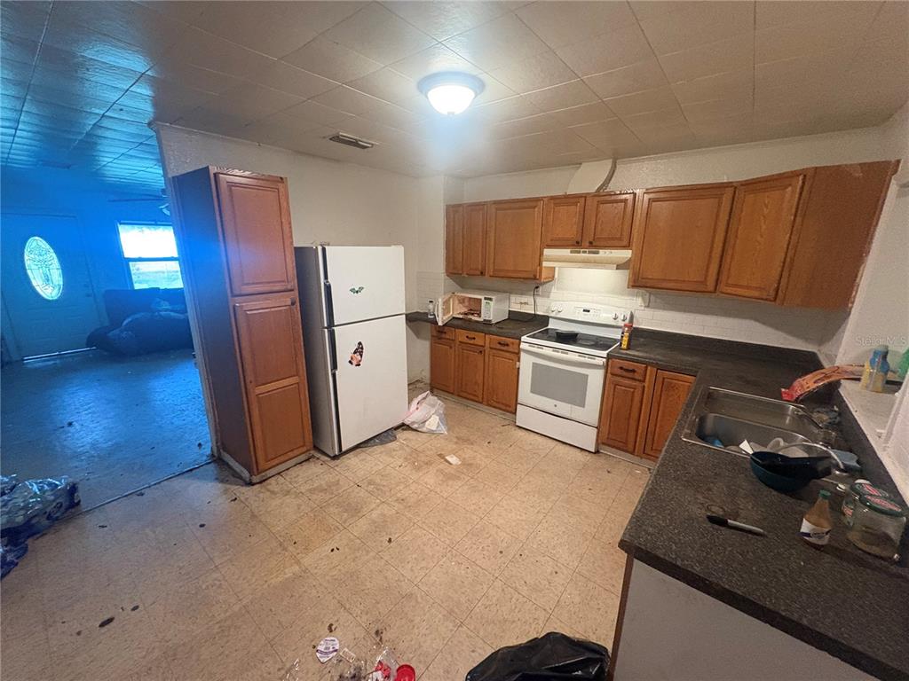 2330 Azalea Court Lakeland, FL 33815 - Photo 8 of 37 a kitchen with stainless steel appliances granite countertop a sink stove and refrigerator