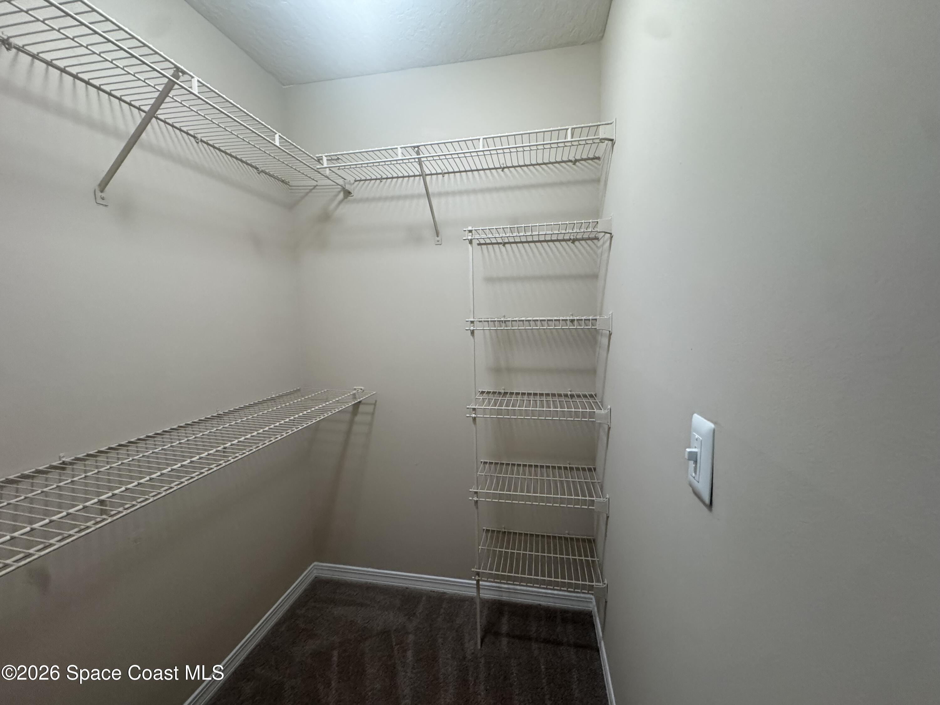 7667 North Wickham Road, Unit 1107 Melbourne, FL 32940 - Photo 11 of 19 a view of walk in closet with empty racks