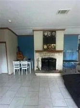 a living room with furniture a fireplace and a table