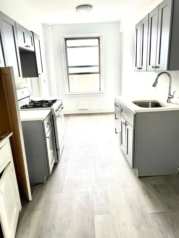 a kitchen with stainless steel appliances granite countertop a sink stove and a refrigerator