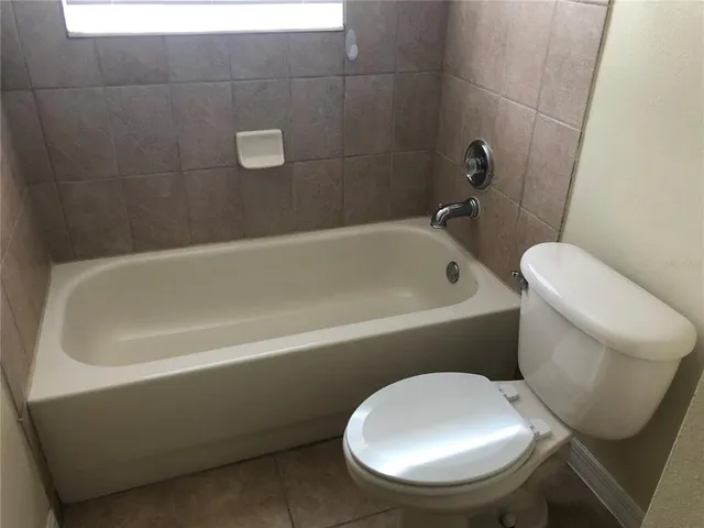 a bathroom with a toilet and bathtub