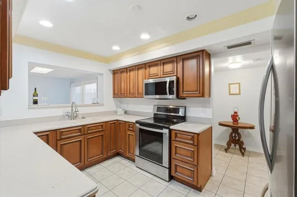 a kitchen with stainless steel appliances a stove sink and cabinets
