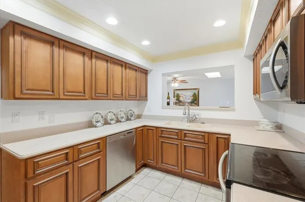 a kitchen with a sink stove and cabinets