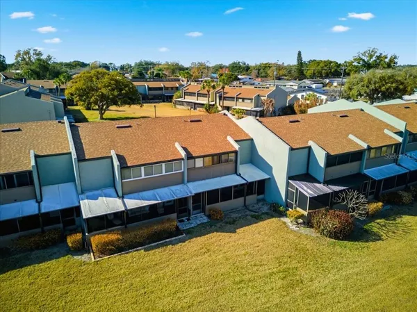 an aerial view of residential houses with outdoor space