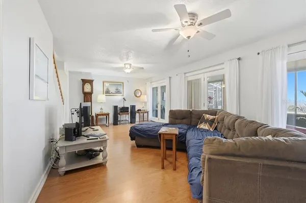 a living room with furniture and a chandelier