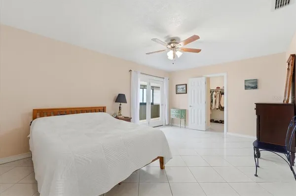 a bedroom with a bed and a chair