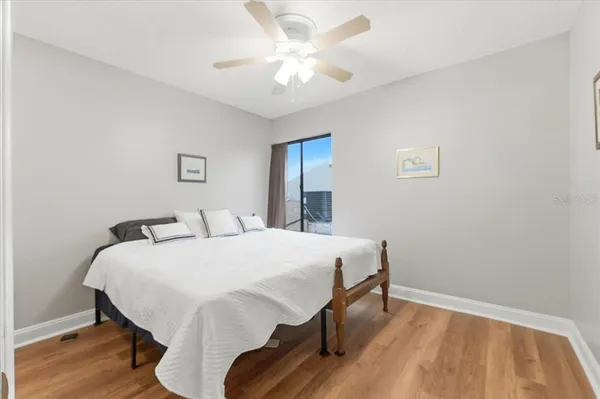 a bedroom with a large bed and a chandelier