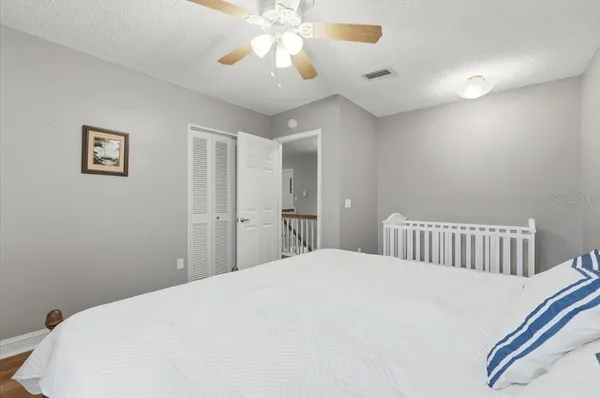a bedroom with a bed and a chandelier