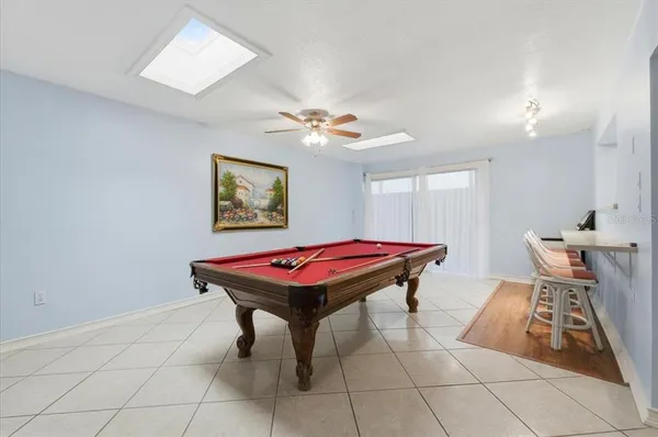 a room with pool table and a chandelier