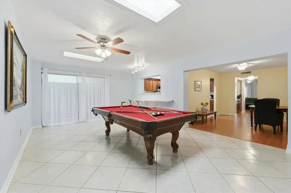 a room with furniture pool table and windows