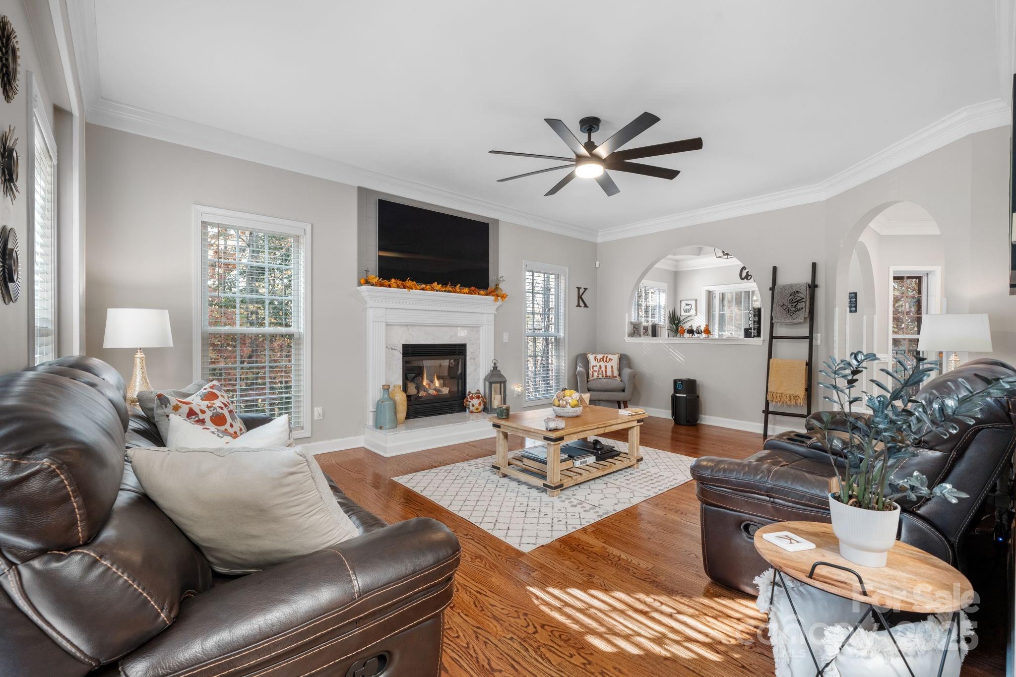 5665 Crown Terrace Hickory, NC 28601 - Photo 13 of 45 a living room with furniture a fireplace and a flat screen tv
