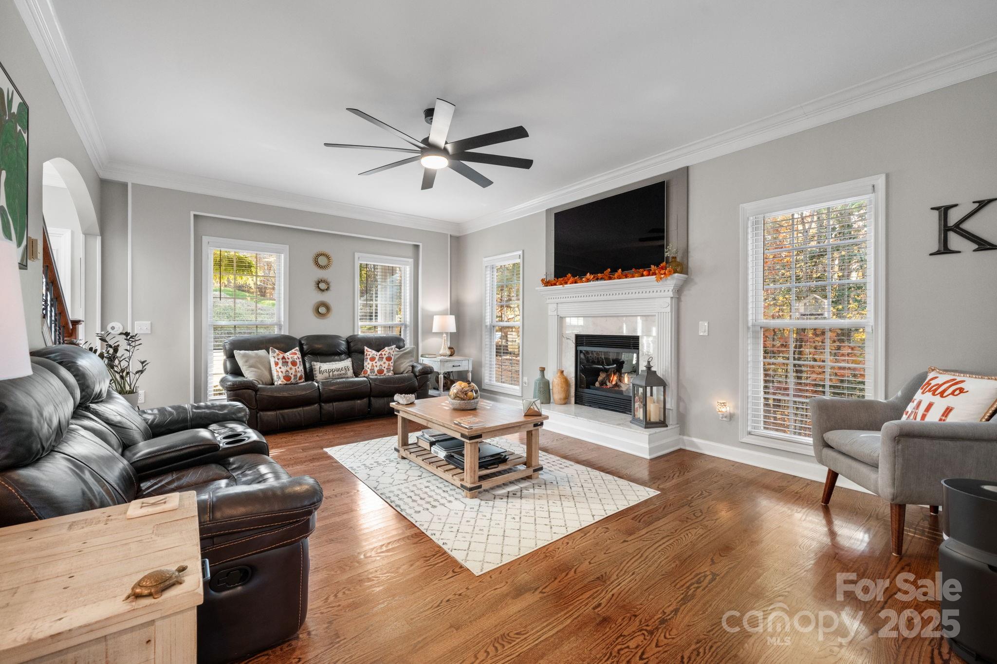 5665 Crown Terrace Hickory, NC 28601 - Photo 14 of 45 a living room with furniture a flat screen tv and a fireplace