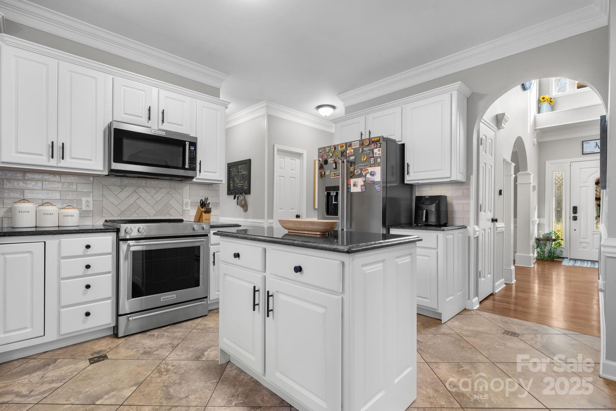 5665 Crown Terrace Hickory, NC 28601 - Photo 17 of 45 a kitchen with stainless steel appliances white cabinets and a stove top oven