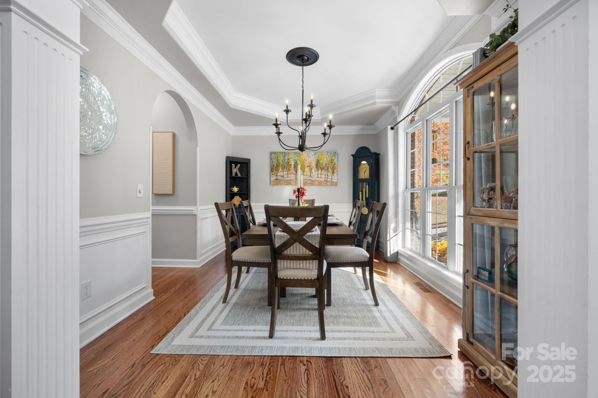 5665 Crown Terrace Hickory, NC 28601 - Photo 21 of 45 a view of a dining room with furniture a chandelier and wooden floor