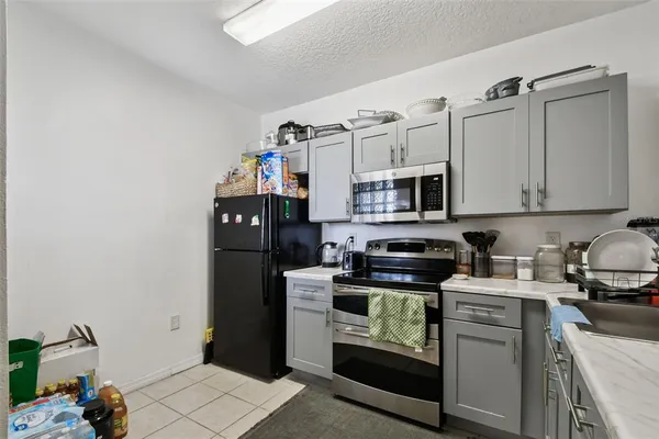 a kitchen with stainless steel appliances a stove microwave and refrigerator