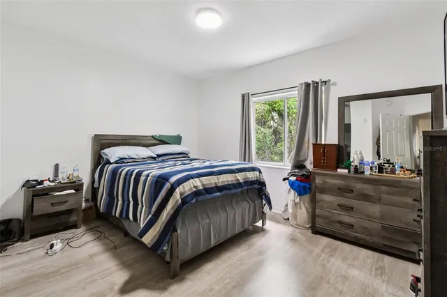 a bedroom with a bed and a dresser