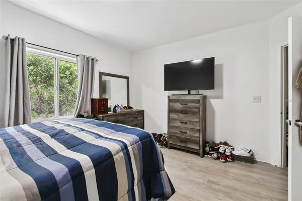 a bedroom with a bed and a flat tv screen