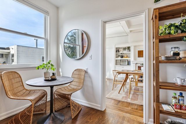 a dining room with furniture and wooden floor