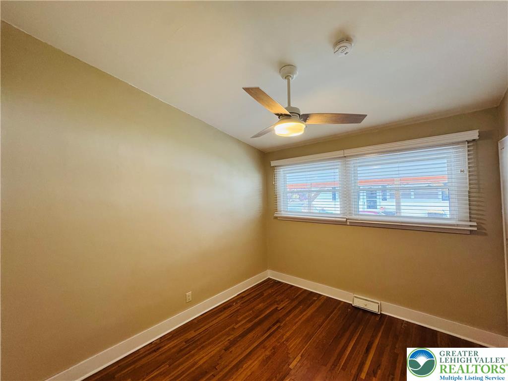 1522 Elayne Street Bethlehem, PA 18017 - Photo 14 of 25 a view of an empty room with wooden floor and a window