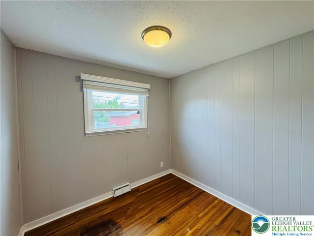 a view of a room with wooden floor and window