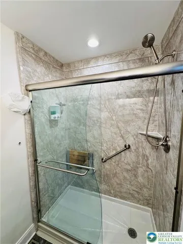 a bathroom with a shower and a sink