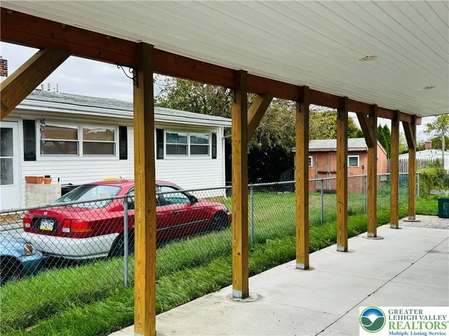 a backyard of a house with yard table and chairs