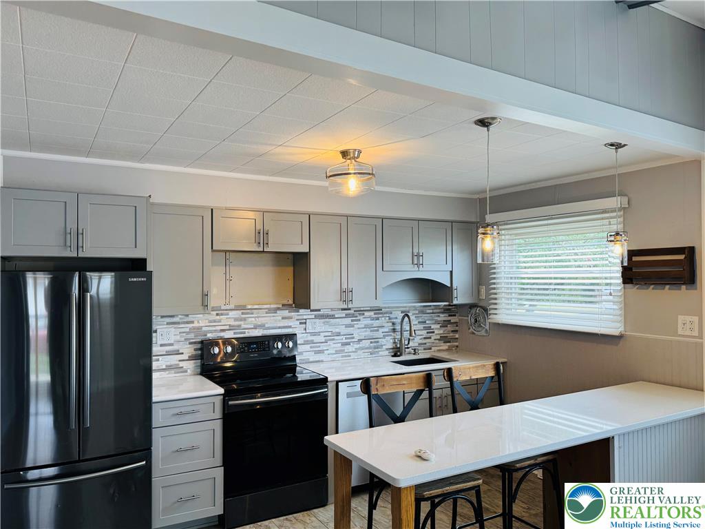 1522 Elayne Street Bethlehem, PA 18017 - Photo 7 of 25 a kitchen with a refrigerator and a stove top oven