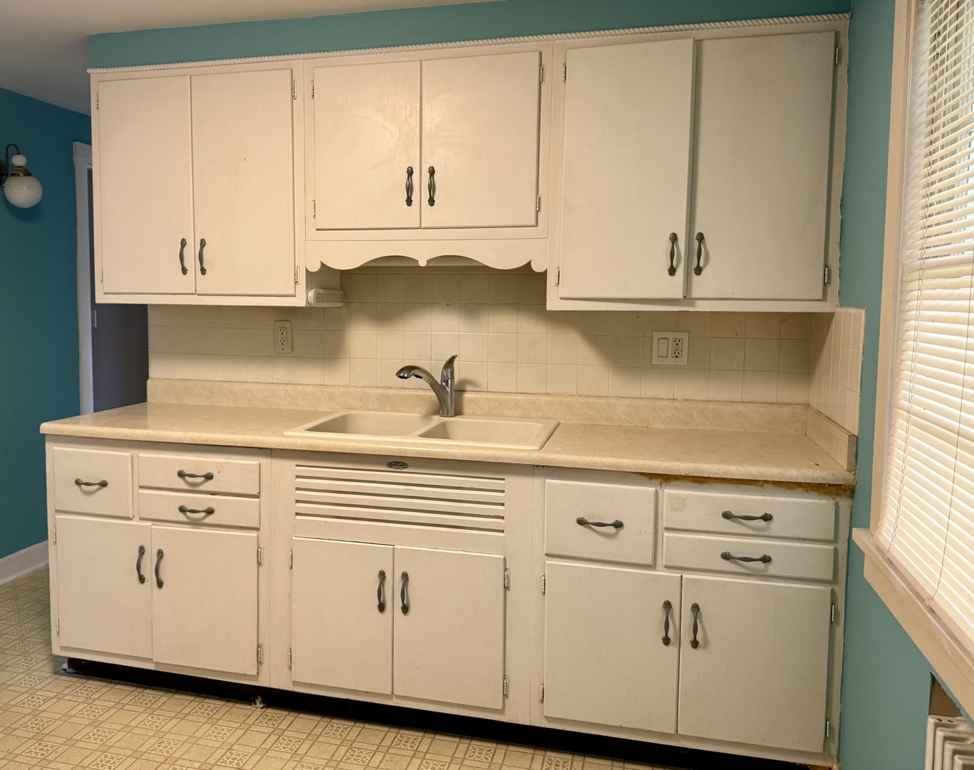 8 North Harrison Street Batavia, IL 60510 - Photo 8 of 22 a kitchen with white cabinets and a stove with a sink