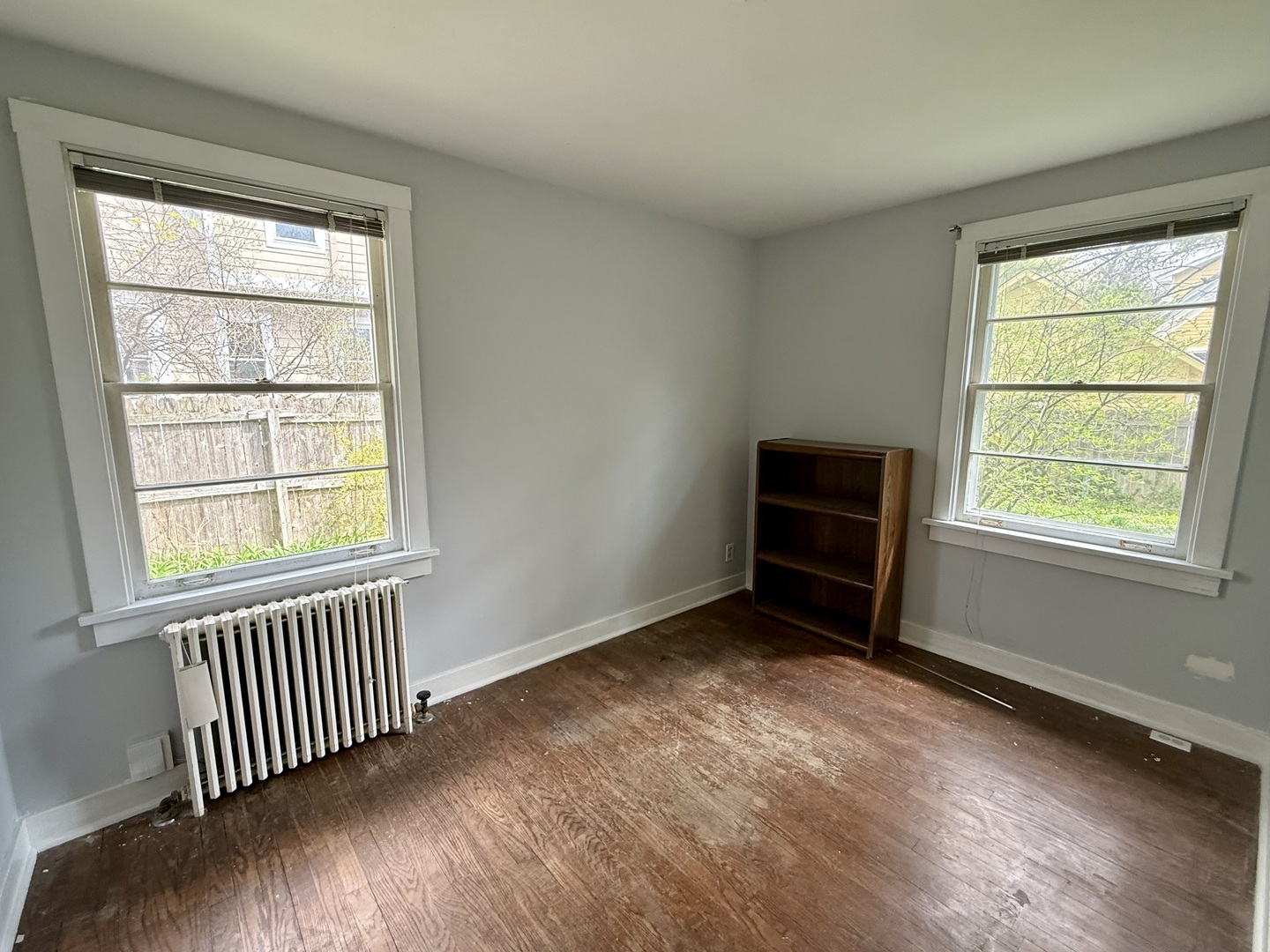 8 North Harrison Street Batavia, IL 60510 - Photo 9 of 22 a view of an empty room with wooden floor and a window