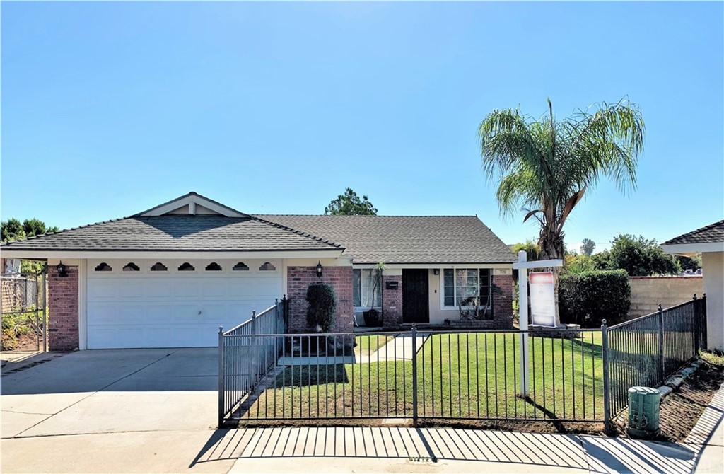 7720 Solvang Place Riverside, CA 92503 - Photo 1 of 1 a front view of a house with garden