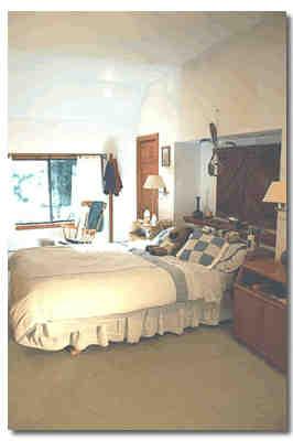 12 Cronk Road Sandisfield, MA 01255 - Photo 5 of 6 a bed sitting in a bedroom next to a larger window