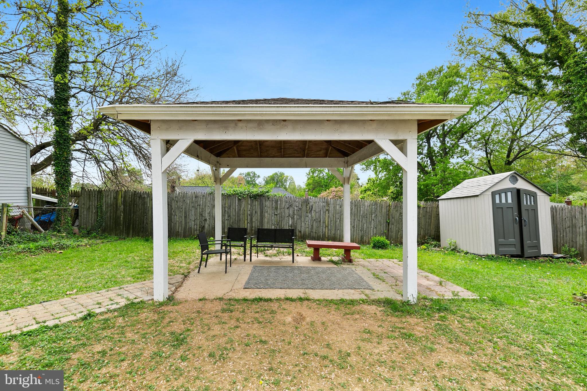 2920 Weisman Road Silver Spring, MD 20902 - Photo 28 of 32 a view of a patio with a table and chairs under a large tree