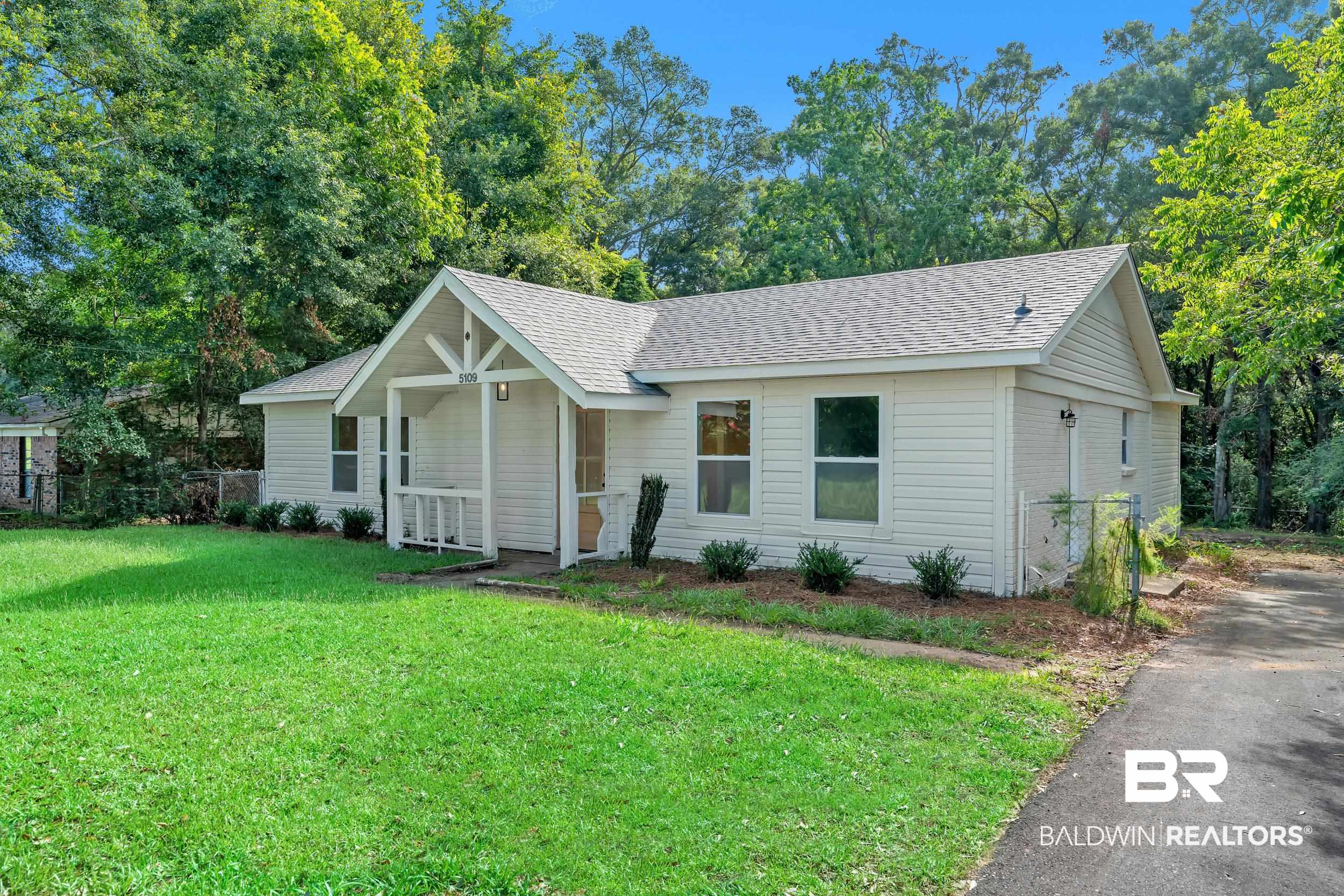 5109 McDonald Road Theodore, AL 36582 - Photo 2 of 21 Single-story residence featuring light-colored siding and a gabled roofline
