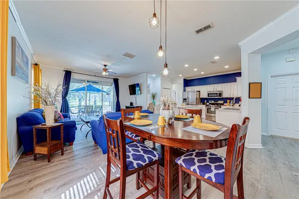 a dining room with a table chairs and a kitchen view