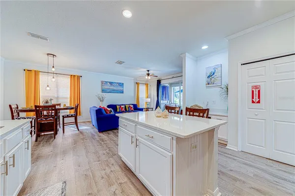 a kitchen that has a lot of cabinets in it and wooden floors
